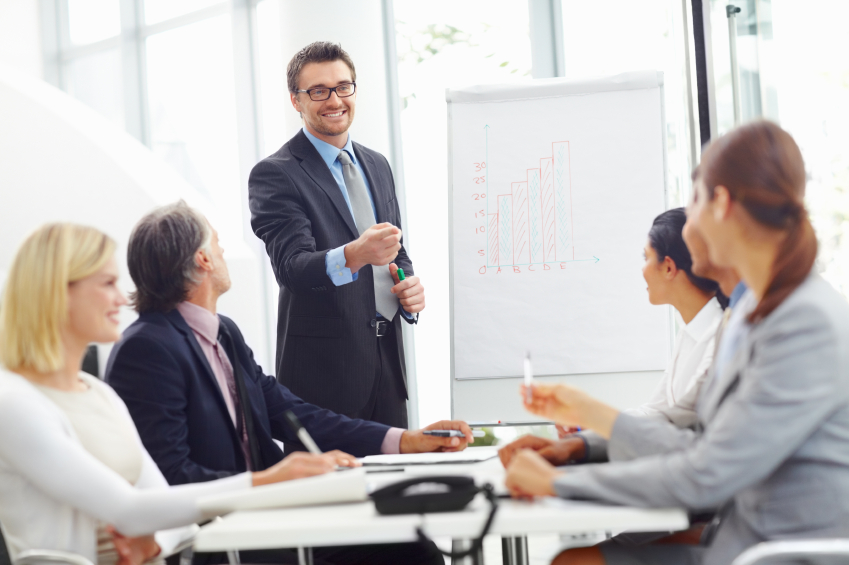 Portrait of successful young business man presenting to his colleagues in meeting